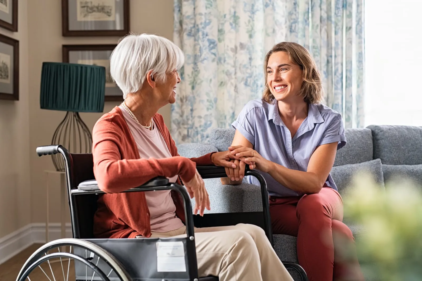 A caregiver helping an older adult walk safely